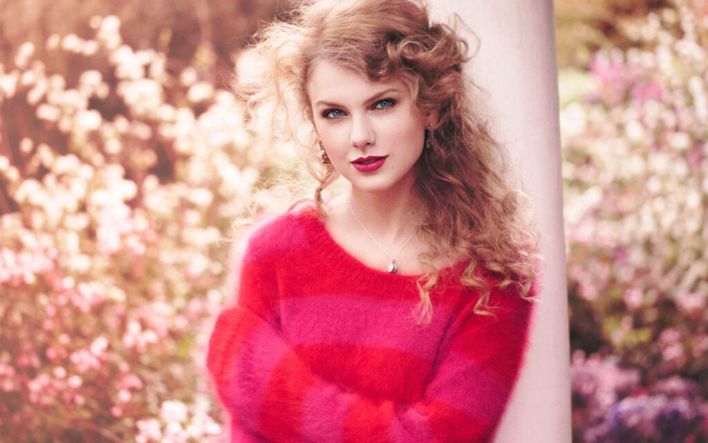 Electric Performance: Taylor Swift in a Pink-Red Ensemble Wallpaper