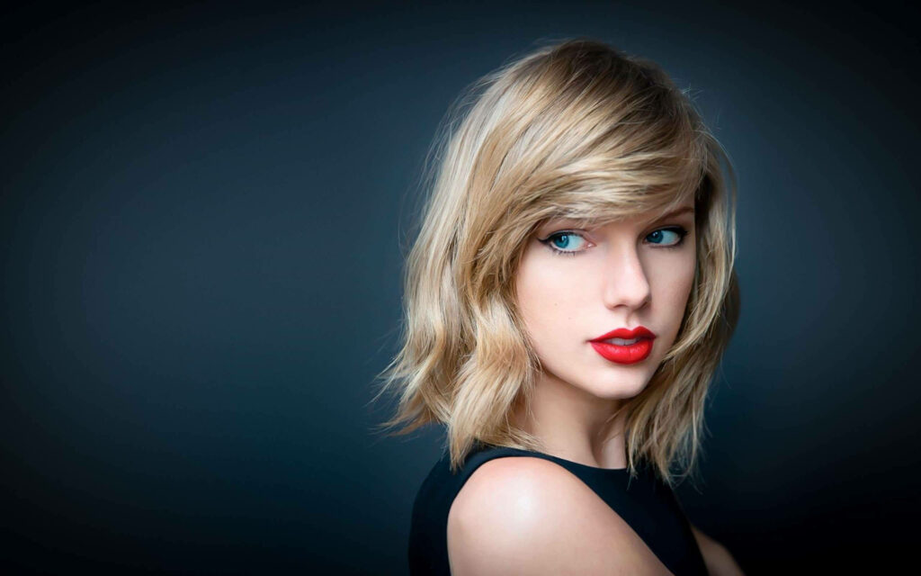 Taylor Swift wallpaper with bold red lipstick soft waves signature style and elegant look