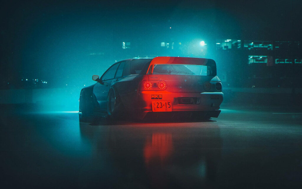 Teal and red JDM car with bold wing under moody urban lights and misty night skyline background Wallpaper