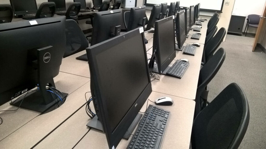 Immersive Full HD Computer Desktop Environment - Captivating Room Setup with Long Light Brown Desks Wallpaper