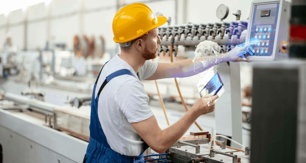 Technician in Hard Hat Using Tablet for Equipment Maintenance Wallpaper