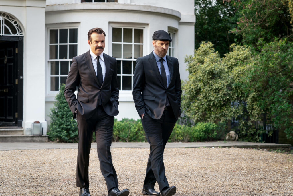 Ted Lasso & Friend in Tuxedos: Charming Wallpaper Background