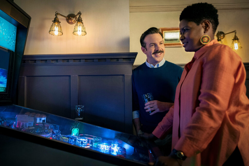 Cheerful Ted Lasso Chats by Pinball: Cozy Wallpaper Vibe