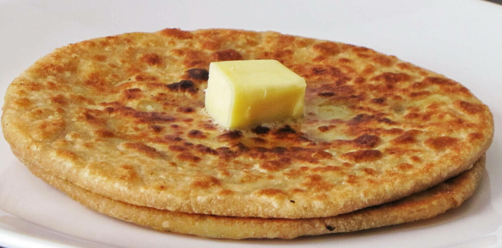 Golden-Brown Flatbread with Butter: Delicious Wallpaper Background