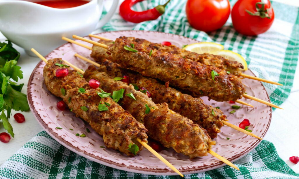 Savory Delights: A Mouthwatering HD Wallpaper Featuring Lyulya Kebab and Juicy Tomato