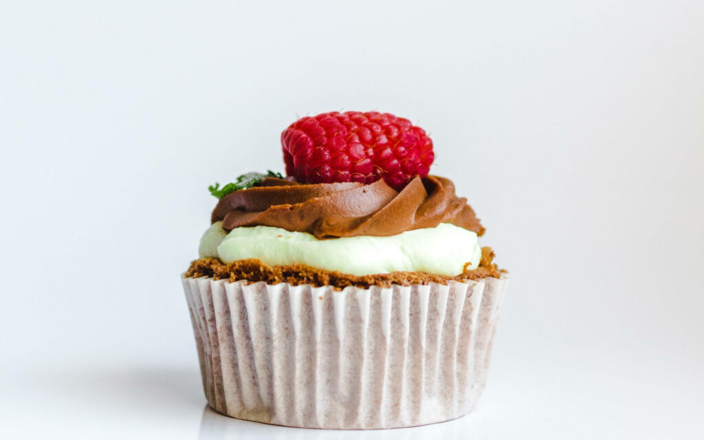 Savoring the Sweet Indulgence: Delectable Raspberry Chocolate Cupcake Delight Wallpaper
