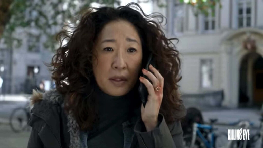 Tense Killing Eve Moment: Concerned Character on Phone - Wallpaper