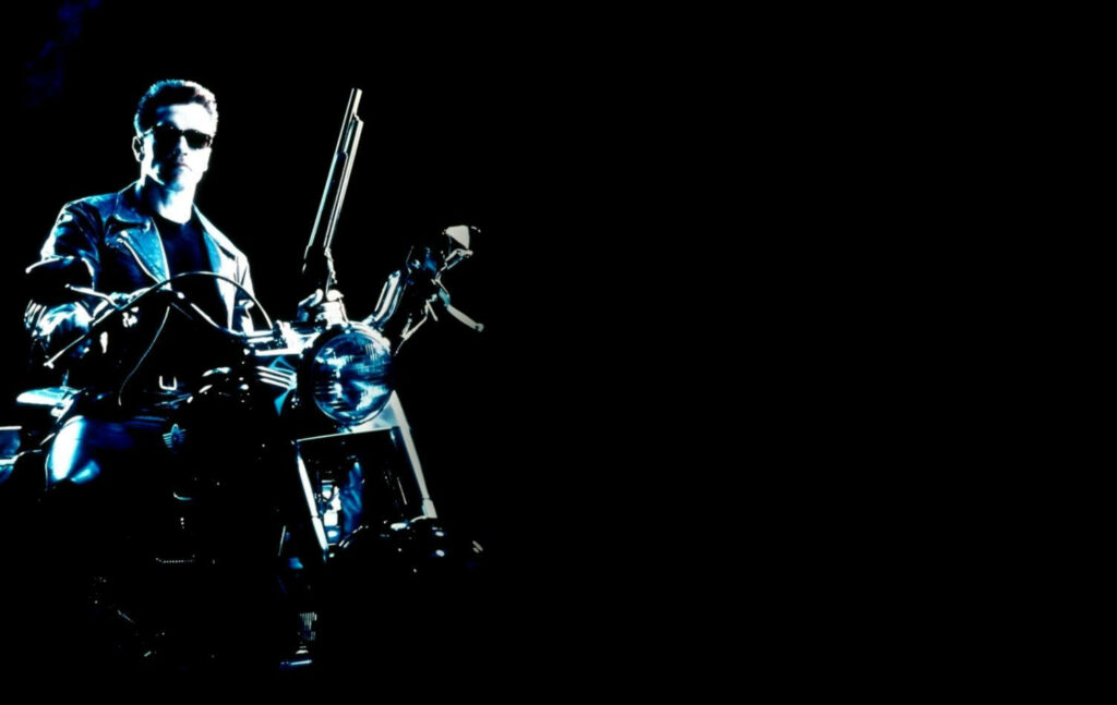 Terminator Judgment Day wallpaper featuring Terminator with shotgun on motorcycle dark background