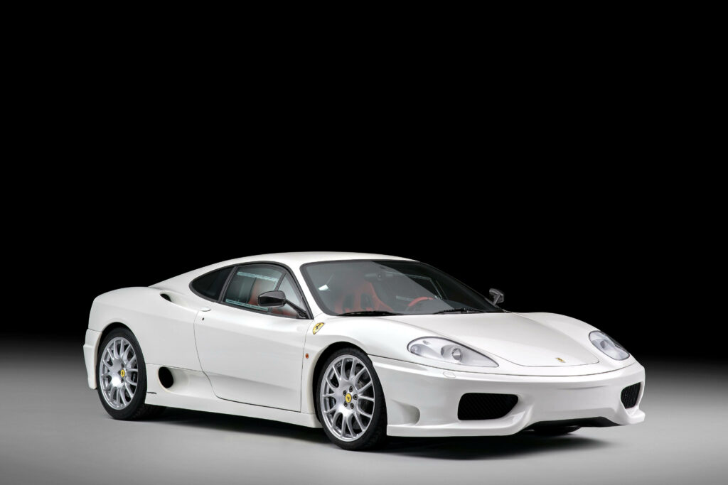 The Enigmatic White Stallion: A Captivating Snapshot of a Ferrari Sports Car Embracing Shadows Wallpaper