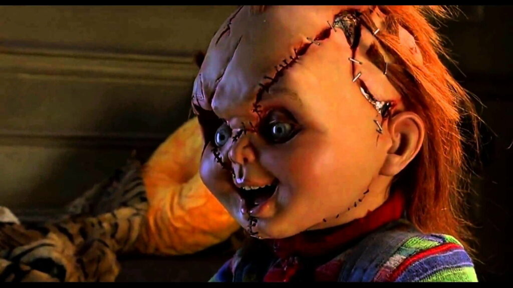 Creepy Chucky: A Bone-Chilling Horror Movie Doll Captured on HD Wallpaper Background