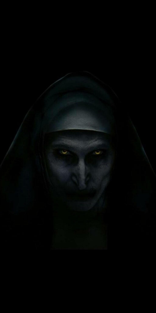 Terrifying old nun with glowing yellow eyes emerging from dark horror wallpaper background