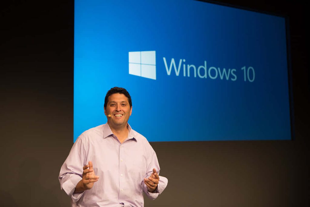 Terry Myerson keynote presentation with Windows 10 logo on screen at software launch event Wallpaper