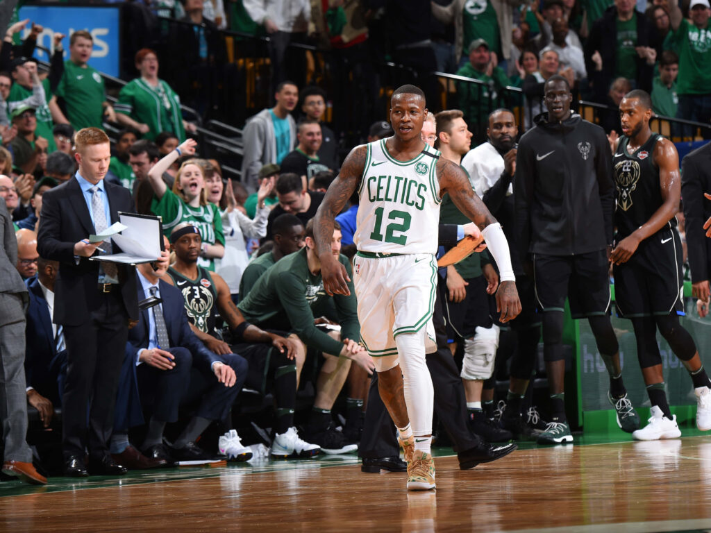 Terry Rozier in white Boston Celtics jersey 12 walking on court with fans and teammates NBA game Wallpaper