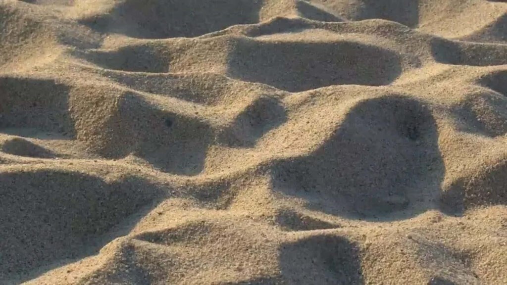 Stunning Close-Up of Textured Beach Sand Dunes - Wallpaper Background