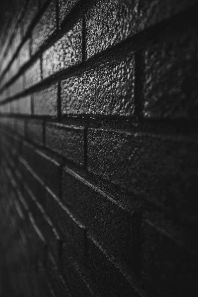 Textured Black Brick Wall Wallpaper - Dramatic Rugged Background