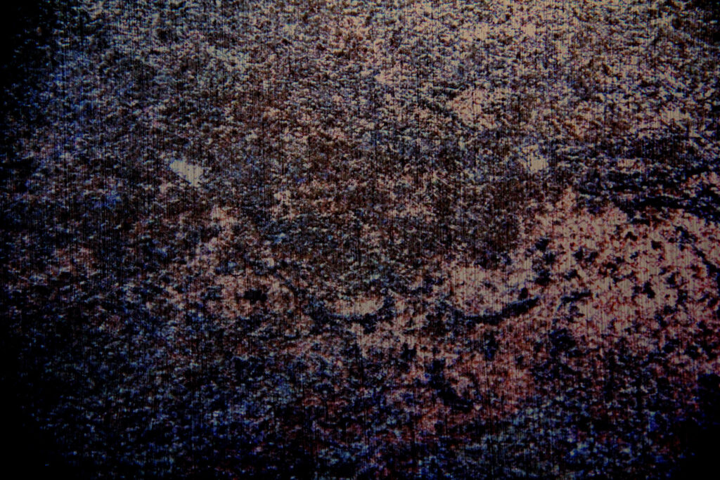Textured Black Grunge Wallpaper with Dark Tones and Hints of Color