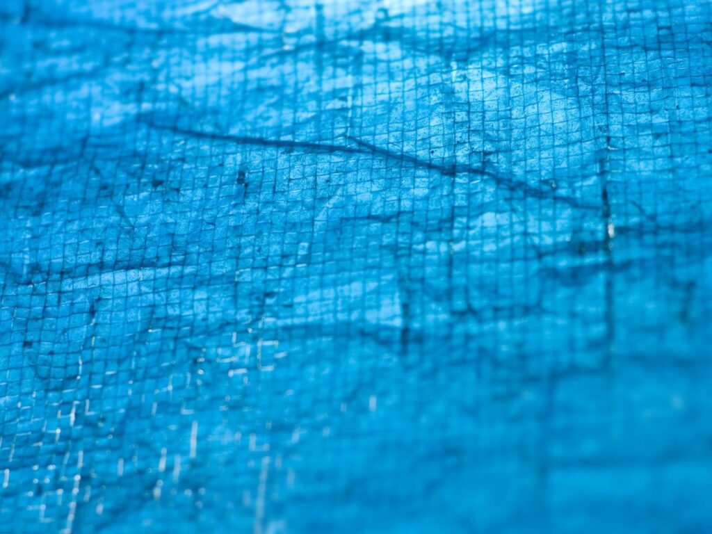 Textured Blue Wallpaper: Close-Up of Intersecting Lines & Translucent Design
