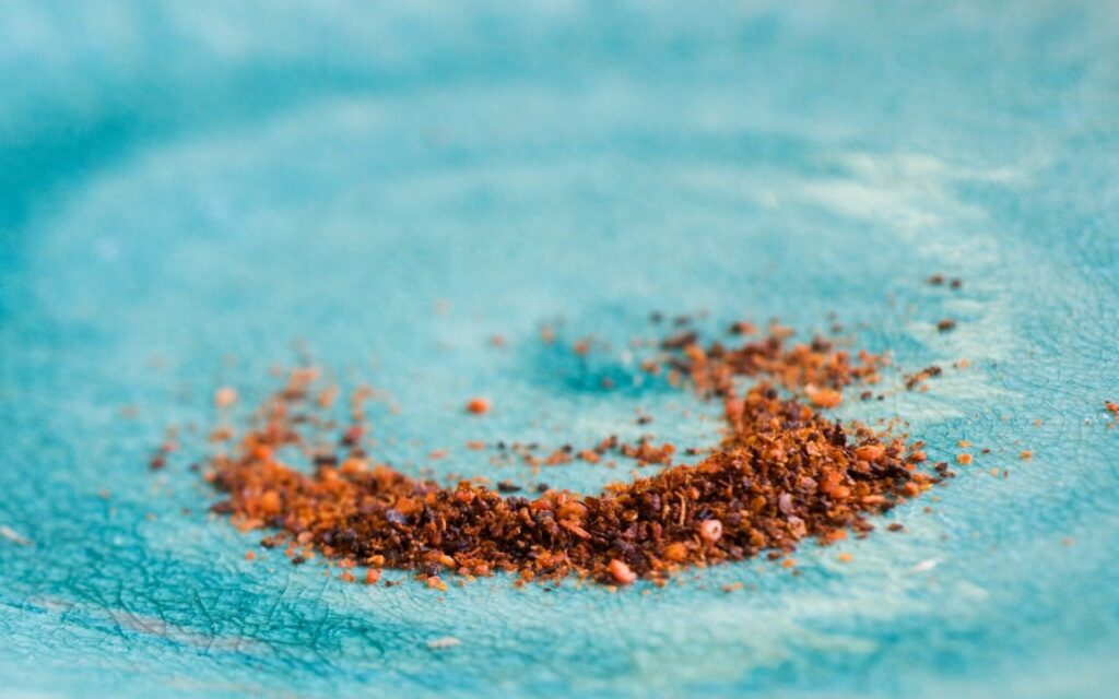 Textured Blue Surface with Brown Particles - Wallpaper Background