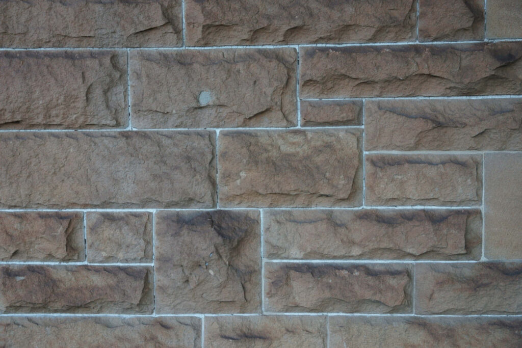 Textured Brick Wall Close-Up: Rugged Stone Wallpaper Background
