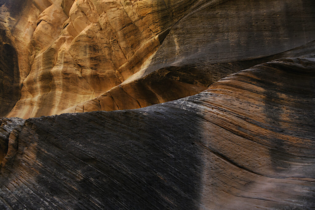 Textured canyon wall wallpaper with layered stone and warm earthy tones highlighting rock reliefs