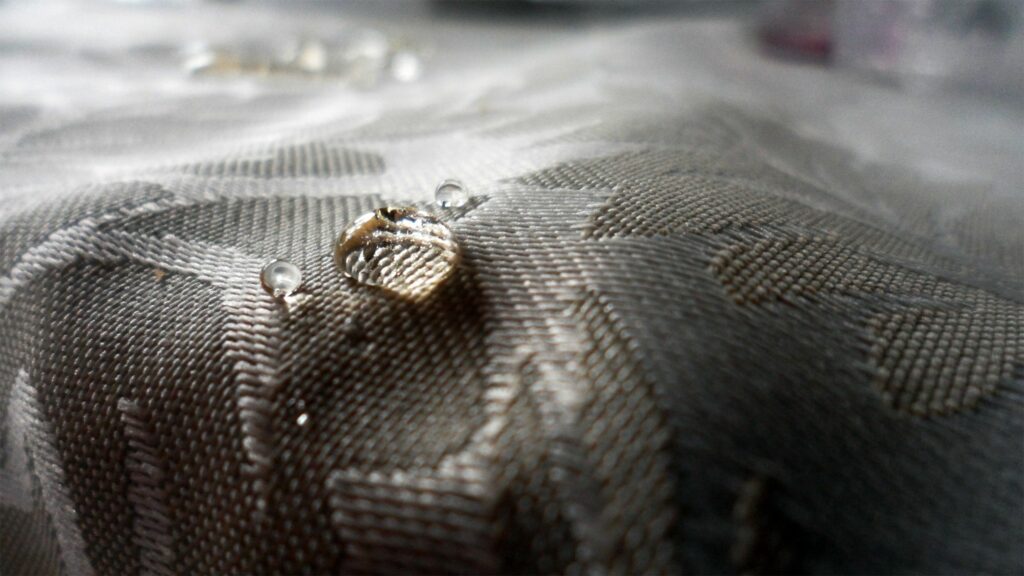 Textured Cloth with Water Droplets: Elegant Wallpaper Background