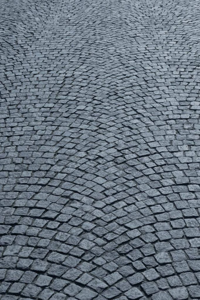 Textured gray cobblestone street wallpaper with elegant fan pattern minimalist iOS background