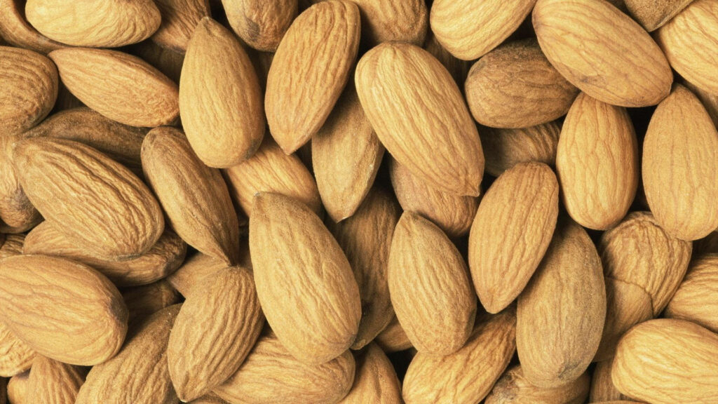 Textured Dry Almond Nuts: Earthy Wallpaper Background Close-Up