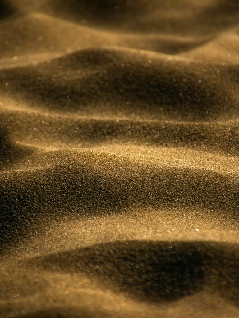 Textured Golden Brown Sand Wallpaper Background - Macro Close-Up