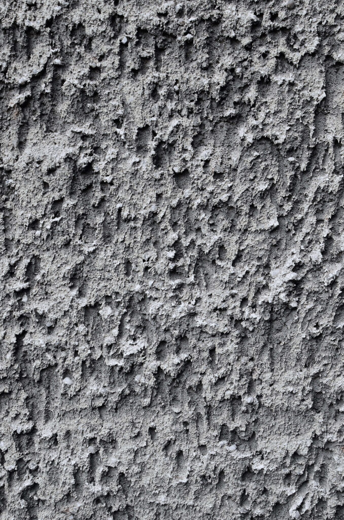 Textured Gray Stucco Wall Close-Up: Artistic Wallpaper Background