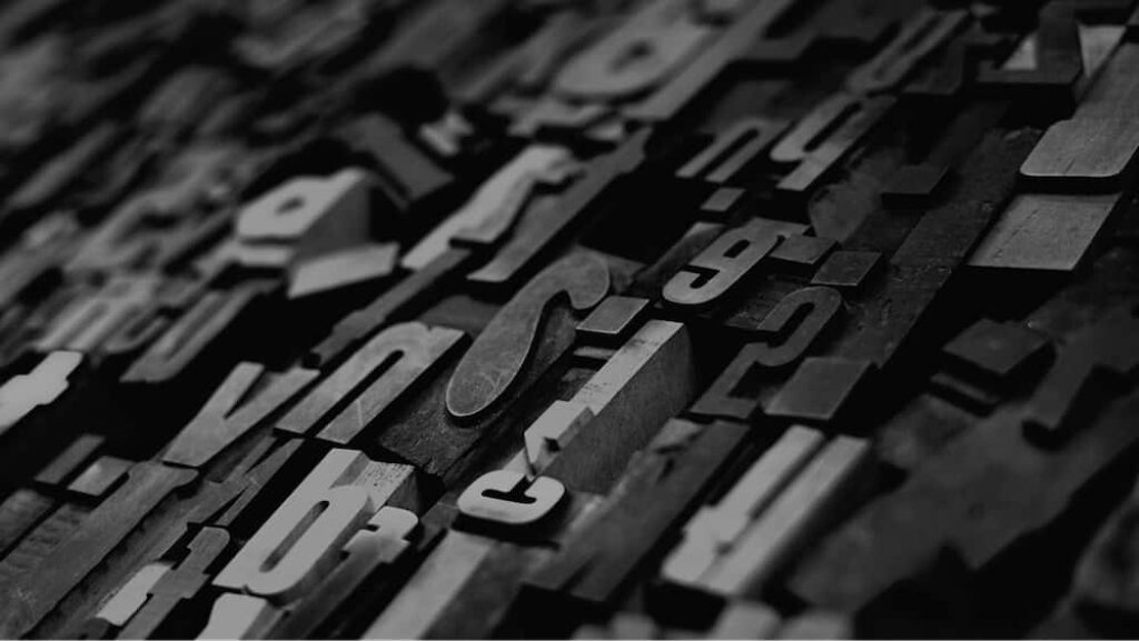Artistic Wooden Letters Wallpaper: Sophisticated Monochrome Background