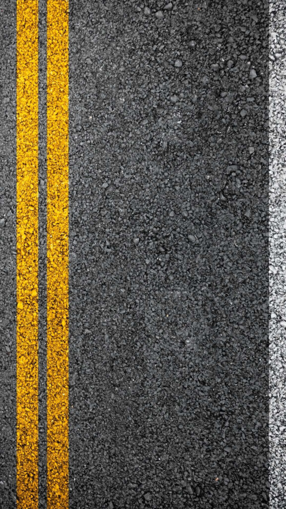 Vibrant Textured Wallpaper: Road Surface with Yellow Lines & White Border