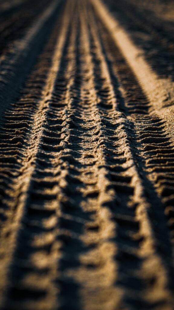 Textured Sand Close-Up: Tire Tread Patterns for Stunning Wallpaper