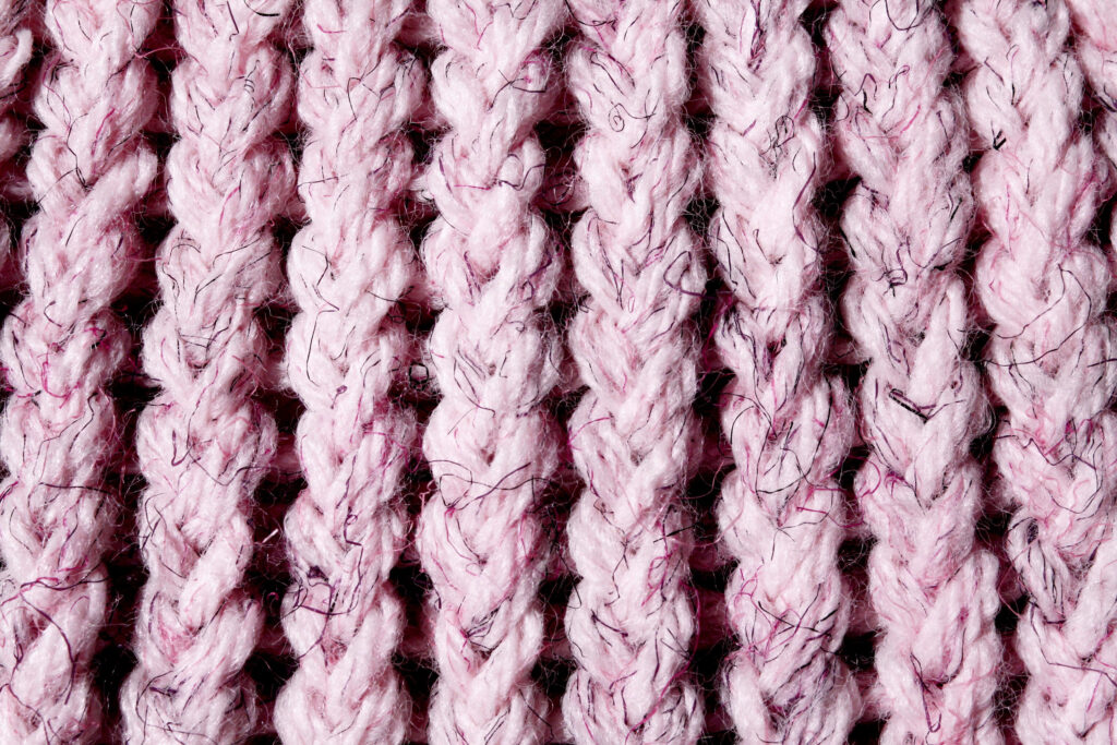 Intricate Soft Pink Wool Knitting Pattern - Textured Wallpaper