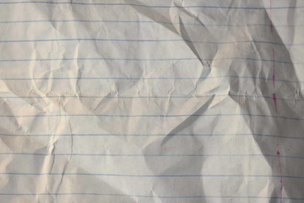 Textured Close-Up of Crumpled Lined Paper - Wallpaper Background
