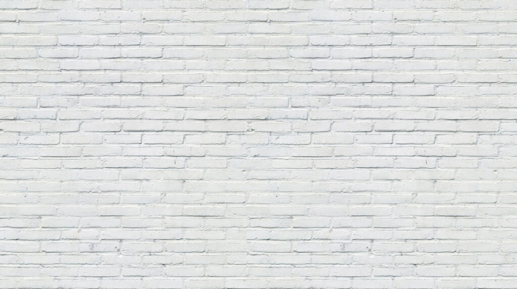 Quintessential QHD: Captivating Cement Patterns on a White Brick Wall Wallpaper