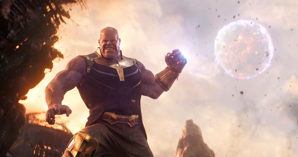Thanos with Infinity Gauntlet glowing fiercely amid chaos wallpaper background powerful scene