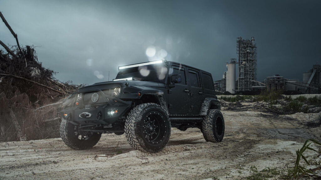 Rugged Thar SUV parked on muddy off-road under cloudy sky showcasing 4K off-road power Wallpaper