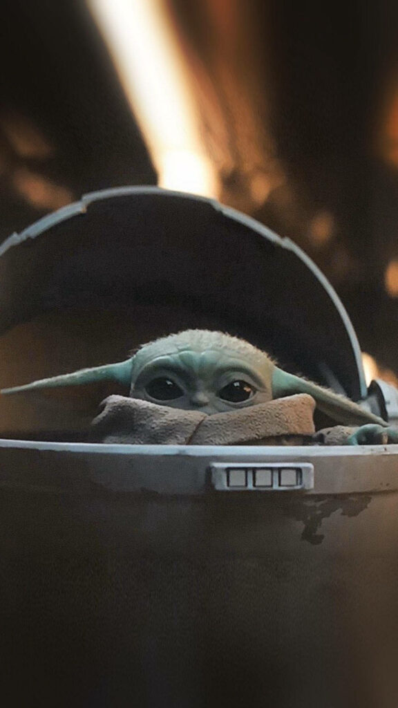 The Adorable Baby Yoda Safely Enveloped in a Protective Capsule: A Delightful Sight! Wallpaper