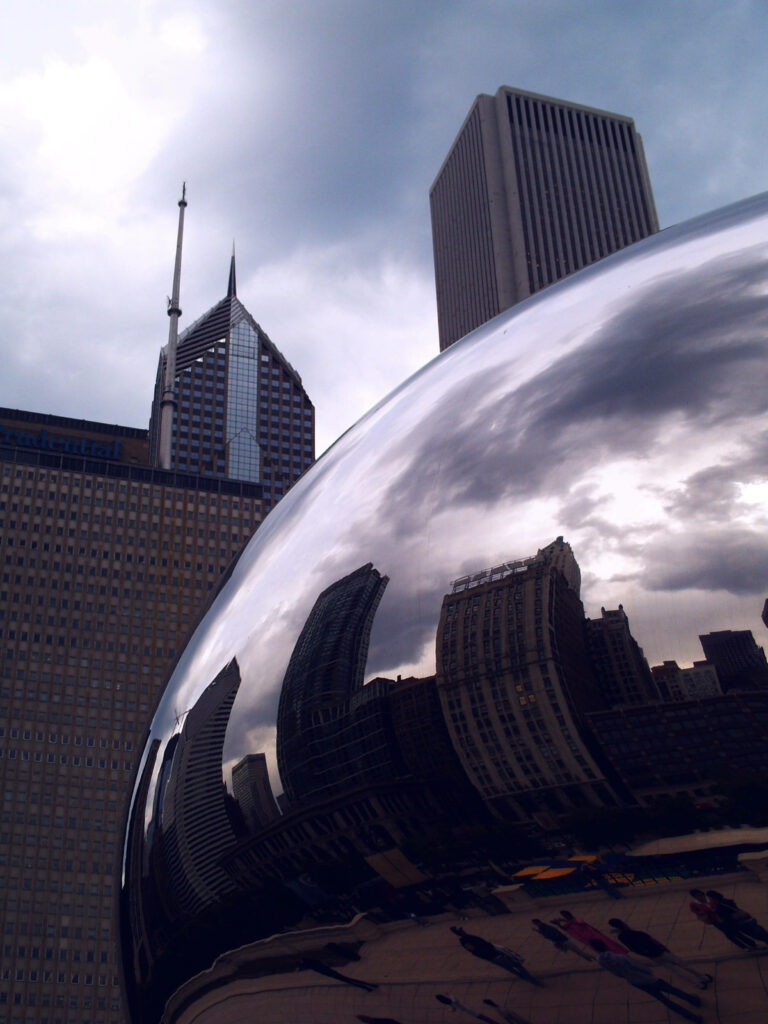 Close-up of Chicago Bean reflecting city skyline with dramatic overcast sky urban wallpaper