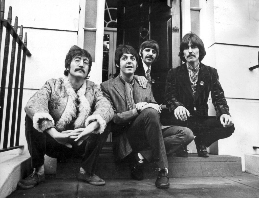 The Beatles relaxed pose at doorway iconic candid wallpaper background John Paul George Ringo