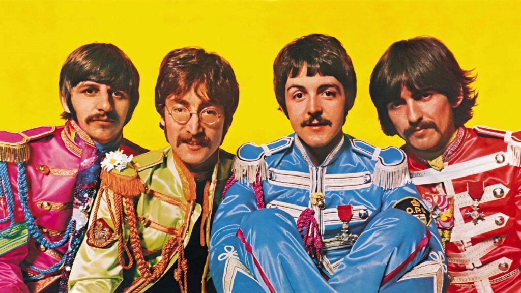 The Beatles Rock Band in colorful Sgt Peppers outfits on bright yellow HD wallpaper background