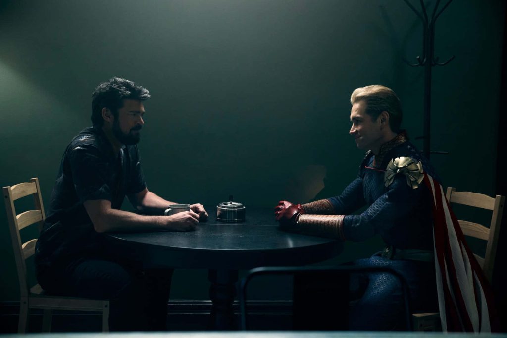 Billy Butcher and Homelander intense stare-down in dim interrogation room The Boys wallpaper