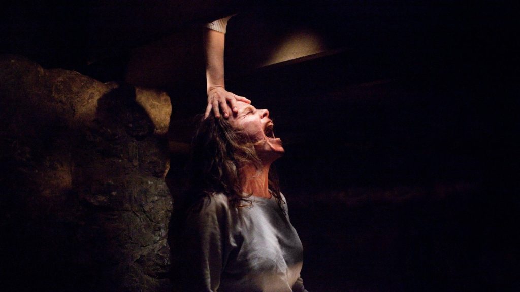 Carolyn Perron possessed screaming in dark cellar intense supernatural horror movie scene wallpaper