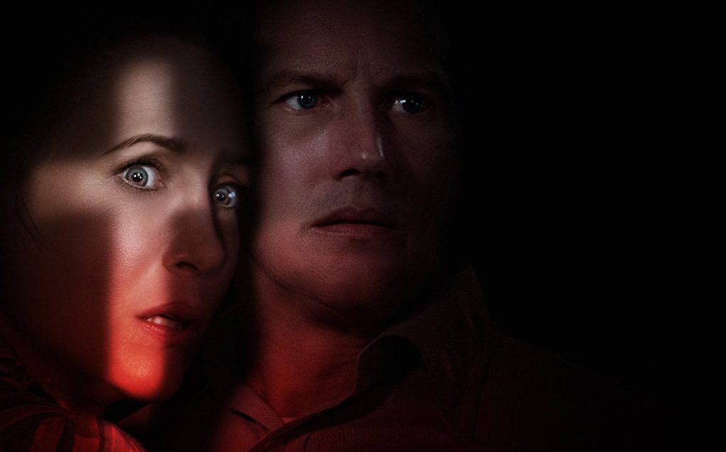 The Conjuring wallpaper with Ed and Lorraine Warren in red light spooky background suspense scene