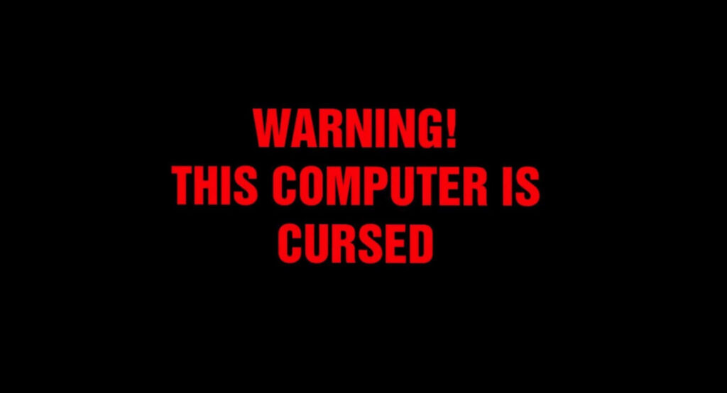 Sinister Warnings on Frightful Wallpaper: Cursed Computer Haunts the Darkness