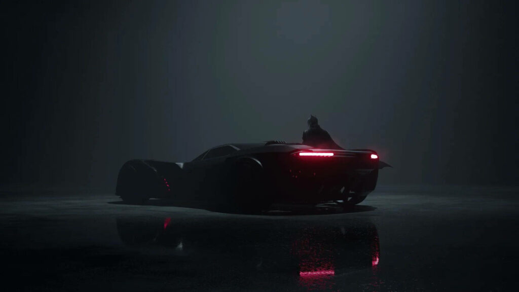 The Dark Knight's Silent Vigil: Batman and his Iconic Batmobile Embrace Shadows in Minimal Lighting Wallpaper