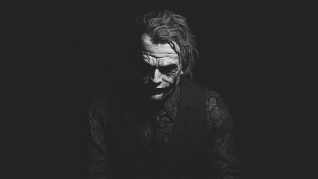 The Enigmatic Transformation: An Iconic Heath Ledger as The Joker - The Dark Knight's Captivating Monochrome Backdrop Wallpaper