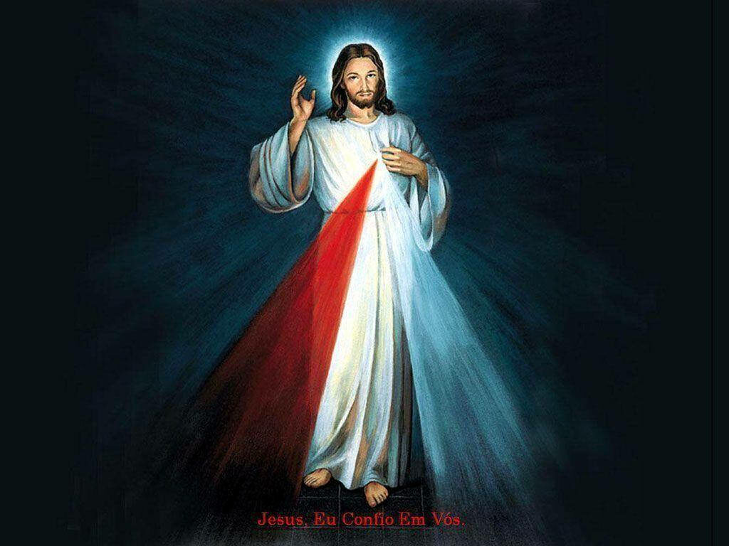 Holy Illumination: Jesus Christ Radiating Divine Rays amidst Electric Blue Ambiance - God's Laptop Background Wallpaper