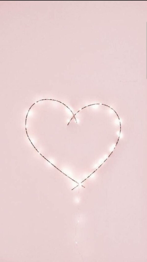 Dreamy Glow: Captivating Illumination with Romantic Heart Installation on Pastel Wall Wallpaper