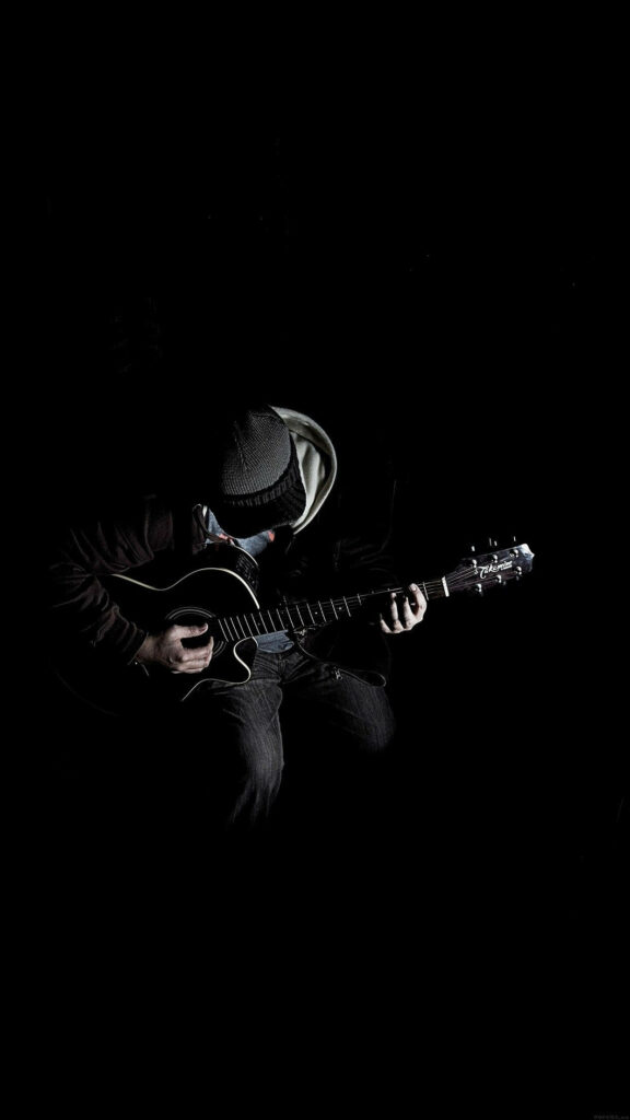 Black Robotic Guitarist Harmonizing with the Shadows: Android Musician Playing a Monochromatic Melody Wallpaper